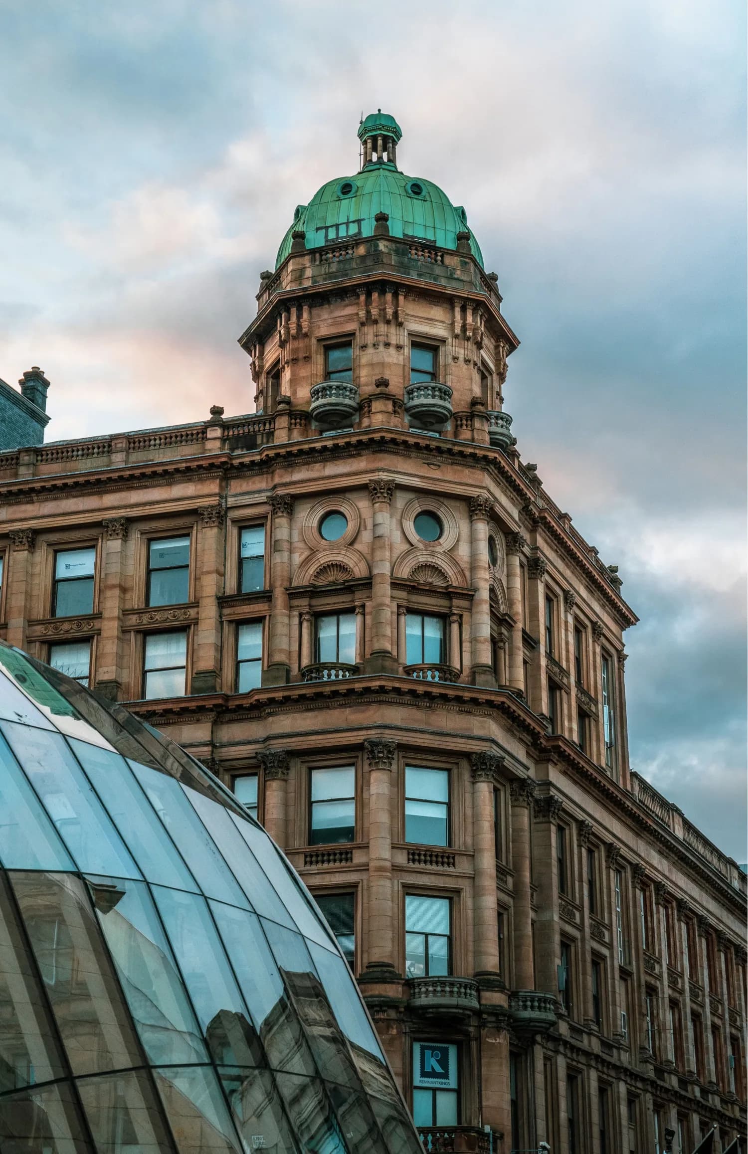 A Glasgow sandstone building with a green copper dome